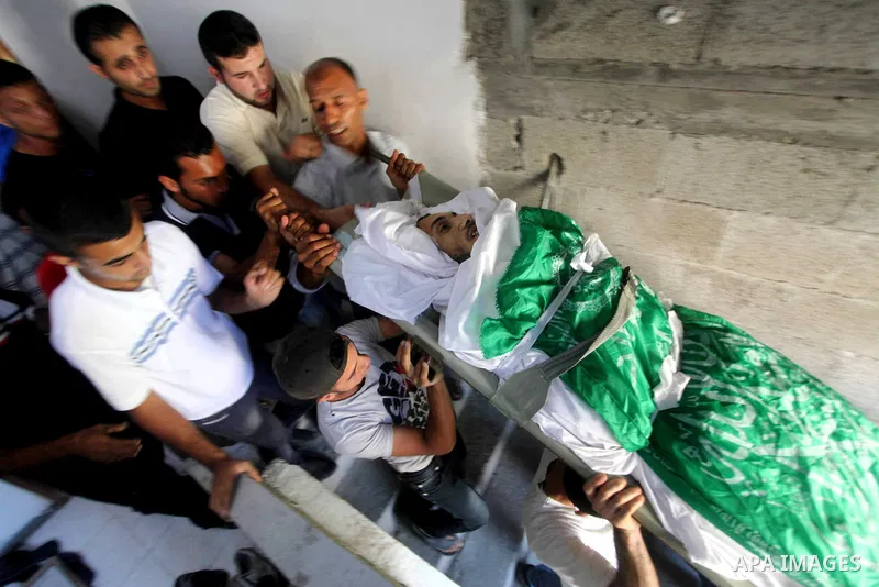 Palestinian mourners carry the body of Khaled al-Burai, 25-years-old, killed in an Israeli drone strike, during his funeral in the Jabalia refugee camp in the northern Gaza Strip on June 23, 2012. The armed wing of Hamas...