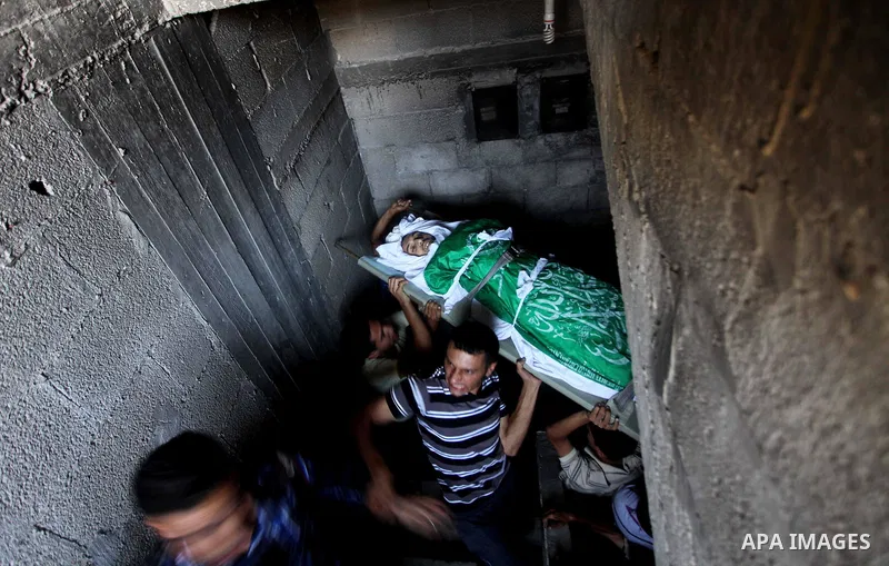 Palestinian mourners carry the body of Khaled al-Burai, 25-years-old, killed in an Israeli drone strike, during his funeral in the Jabalia refugee camp in the northern Gaza Strip on June 23, 2012. The armed wing of Hamas...