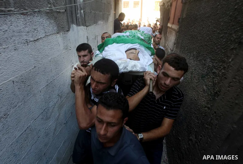 Palestinian mourners carry the body of Khaled al-Burai, 25-years-old, killed in an Israeli drone strike, during his funeral in the Jabalia refugee camp in the northern Gaza Strip on June 23, 2012. The armed wing of Hamas...