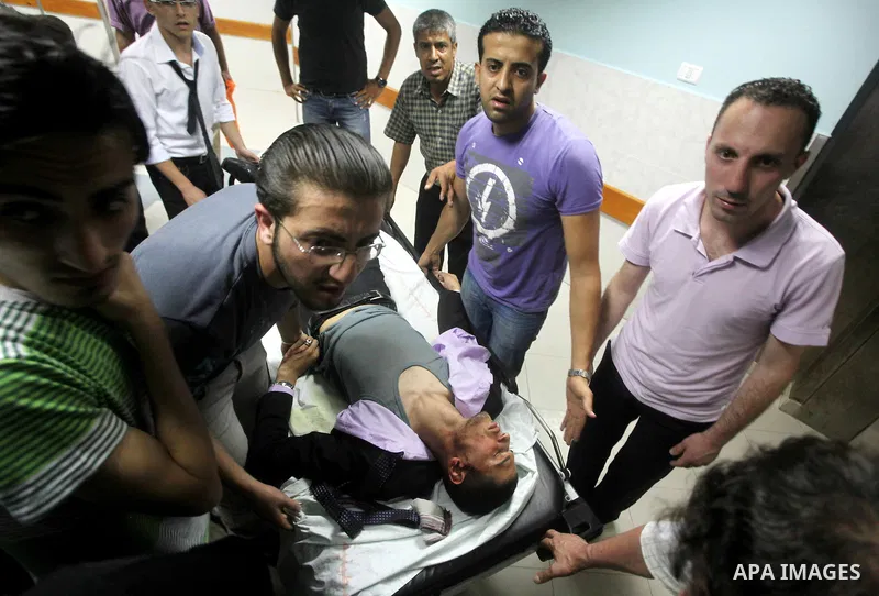Palestinians wheel a wounded man at a hospital in Gaza City, following an Israeli air strike June 23, 2012. Israeli air strikes on Hamas security targets in Gaza killed two Palestinians and wounded 30 people on Saturday,...