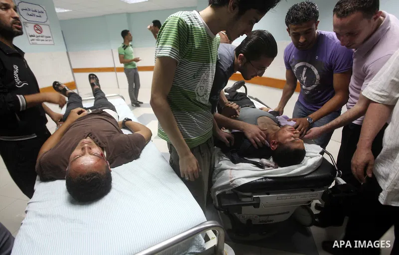 Palestinians wheel a wounded man at a hospital in Gaza City, following an Israeli air strike June 23, 2012. Israeli air strikes on Hamas security targets in Gaza killed two Palestinians and wounded 30 people on Saturday,...