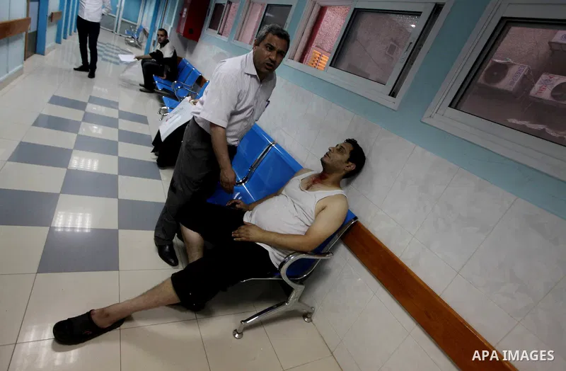A Palestinian medic wheels a wounded man at a hospital in Gaza City, following an Israeli air strike June 23, 2012. Israeli air strikes on Hamas security targets in Gaza killed two Palestinians and wounded 30 people on S...