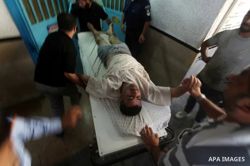 A Palestinian medic wheels a wounded man at a hospital in Gaza City, following an Israeli air strike June 23, 2012. Israeli air strikes on Hamas security targets in Gaza killed two Palestinians and wounded 30 people on S...