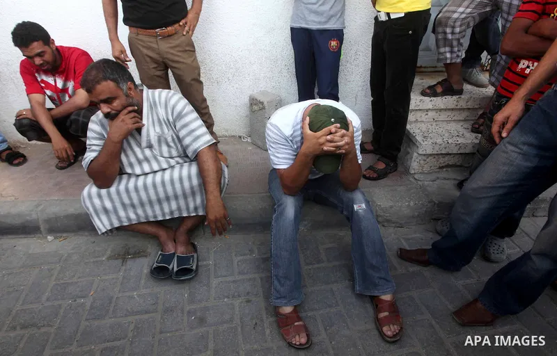 Palestinian relatives of Osama Ali grieves at the morgue after the teenager was killed in an Israeli strike on Gaza City on June 23, 2012. The Palestinian teenager riding a motorcycle was killed, and 10 passers-by wounde...
