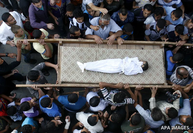 Palestinian mourners carry the body of 6-year-old Ali al-Shwaf during his funeral in Khan Younis, southern Gaza Strip, Saturday, June 23, 2012. Gaza's militant Hamas rulers threatened to escalate fighting with Israel on...