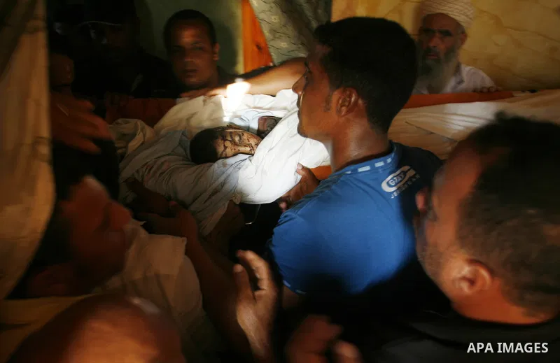 Palestinian mourners carry the body of 6-year-old Ali al-Shwaf during his funeral in Khan Younis, southern Gaza Strip, Saturday, June 23, 2012. Gaza's militant Hamas rulers threatened to escalate fighting with Israel on...
