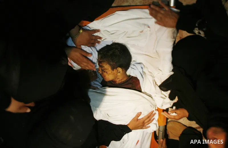 Palestinian mourners carry the body of 6-year-old Ali al-Shwaf during his funeral in Khan Younis, southern Gaza Strip, Saturday, June 23, 2012. Gaza's militant Hamas rulers threatened to escalate fighting with Israel on...