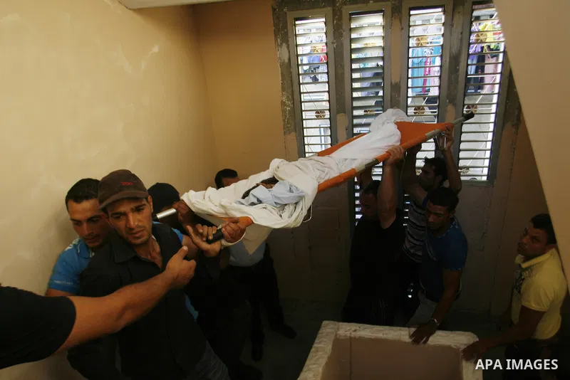 Palestinian mourners carry the body of 6-year-old Ali al-Shwaf during his funeral in Khan Younis, southern Gaza Strip, Saturday, June 23, 2012. Gaza's militant Hamas rulers threatened to escalate fighting with Israel on...