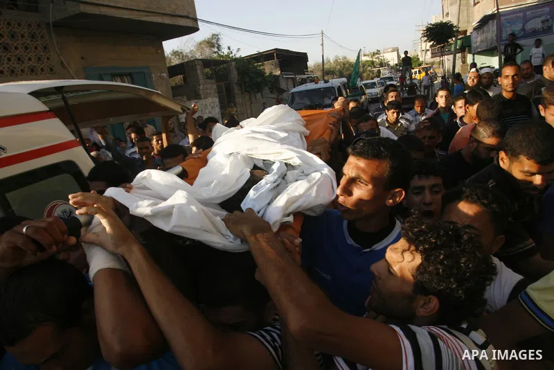 Palestinian mourners carry the body of 6-year-old Ali al-Shwaf during his funeral in Khan Younis, southern Gaza Strip, Saturday, June 23, 2012. Gaza's militant Hamas rulers threatened to escalate fighting with Israel on...