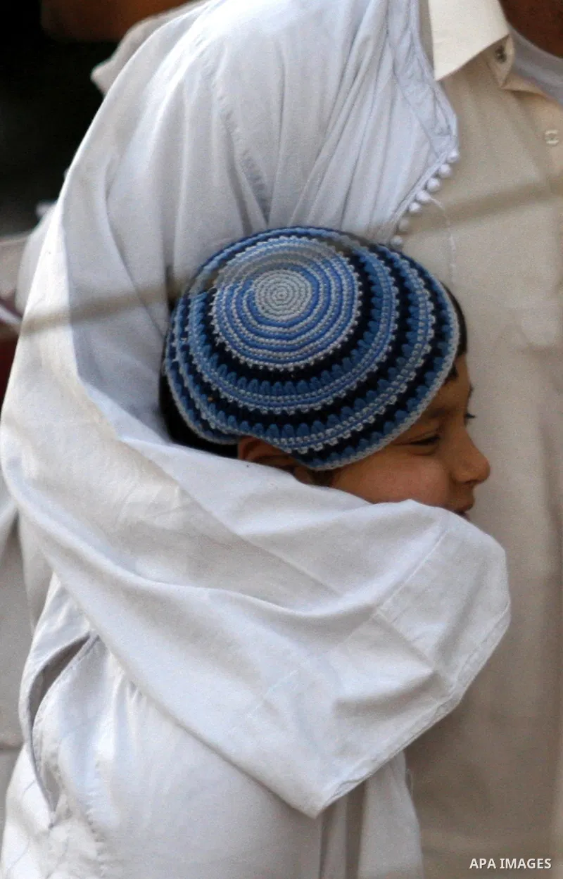 Samaritans attend Shavuot festival on Mount Gerizim near the northern West Bank city of Nablus on June 24, 2012 which is giving of the Torah at Mount Sinai seven weeks after the exodus of the Jewish people from Egypt. Th...