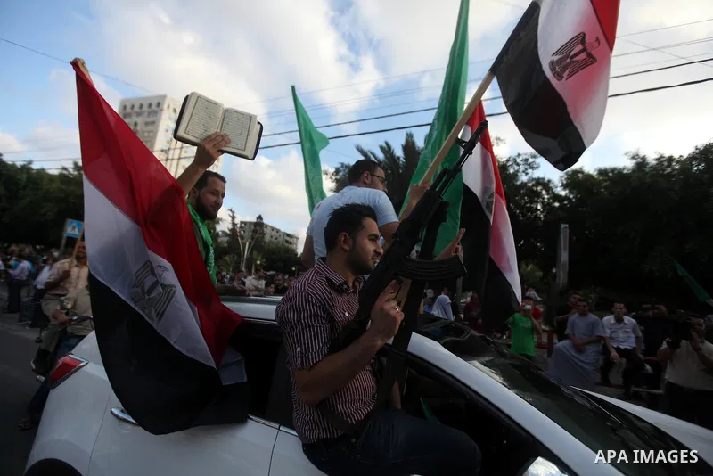 Palestinians hold national and Egyptian flags as they celebrate in Gaza City, the victory of Muslim Brotherhood's presidential candidate, Mohamed Morsi, in the Egyptian elections on June 24, 2012. Arab governments and le...
