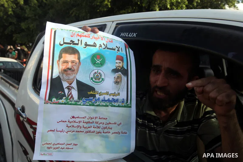 Palestinians hold national and Egyptian flags as they celebrate in Gaza City, the victory of Muslim Brotherhood's presidential candidate, Mohamed Morsi, in the Egyptian elections on June 24, 2012. Arab governments and le...