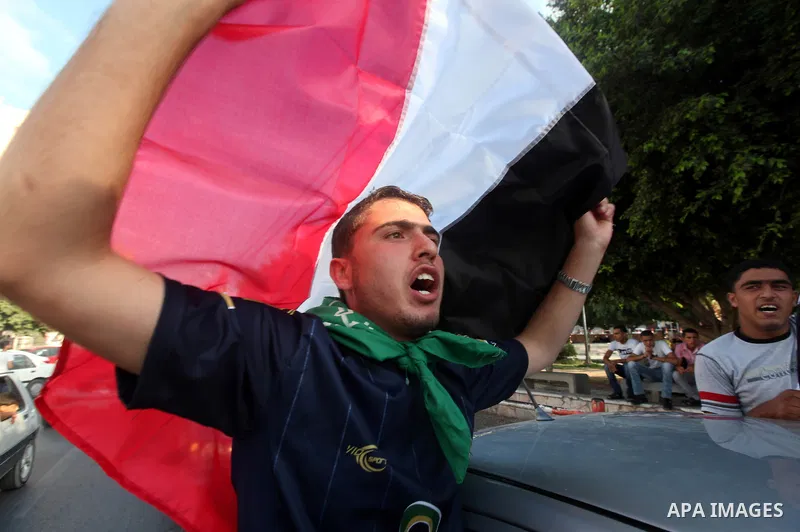 Palestinians hold national and Egyptian flags as they celebrate in Gaza City, the victory of Muslim Brotherhood's presidential candidate, Mohamed Morsi, in the Egyptian elections on June 24, 2012. Arab governments and le...