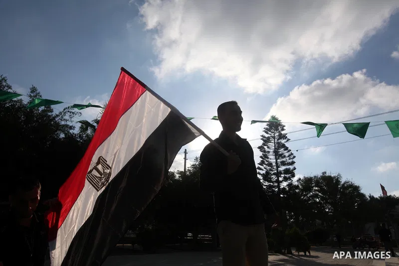 Palestinians hold national and Egyptian flags as they celebrate in Gaza City, the victory of Muslim Brotherhood's presidential candidate, Mohamed Morsi, in the Egyptian elections on June 24, 2012. Arab governments and le...
