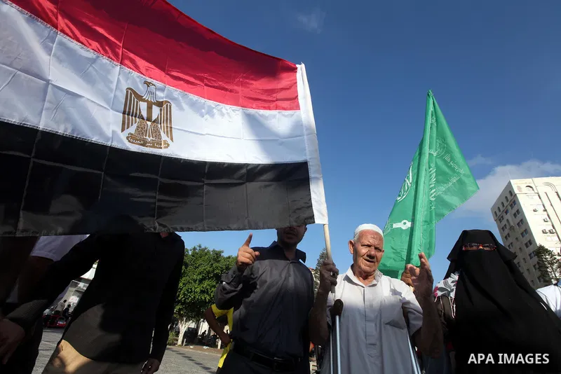 Palestinians hold national and Egyptian flags as they celebrate in Gaza City, the victory of Muslim Brotherhood's presidential candidate, Mohamed Morsi, in the Egyptian elections on June 24, 2012. Arab governments and le...