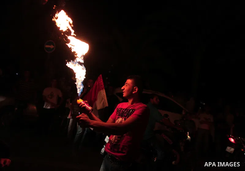 Palestinians hold national and Egyptian flags as they celebrate in Gaza City, the victory of Muslim Brotherhood's presidential candidate, Mohamed Morsi, in the Egyptian elections on June 24, 2012. Arab governments and le...