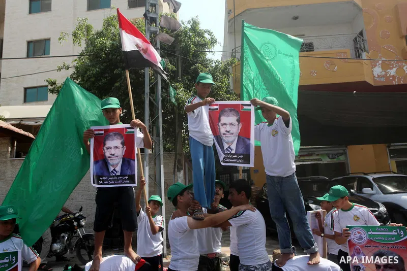 Palestinian boys supporter hold flags of Egypt and Hamas during celebrations after Muslim Brotherhood's presidential candidate Mohamed Morsi's victory in the Egyptian elections, Palestinians gather during a protest in fr...