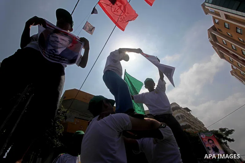 Palestinian boys supporter hold flags of Egypt and Hamas during celebrations after Muslim Brotherhood's presidential candidate Mohamed Morsi's victory in the Egyptian elections, Palestinians gather during a protest in fr...