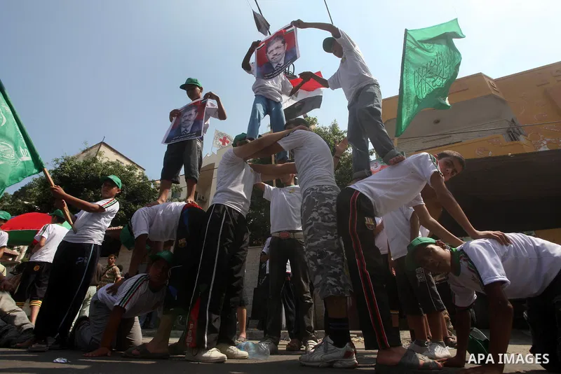 Palestinian boys supporter hold flags of Egypt and Hamas during celebrations after Muslim Brotherhood's presidential candidate Mohamed Morsi's victory in the Egyptian elections, Palestinians gather during a protest in fr...