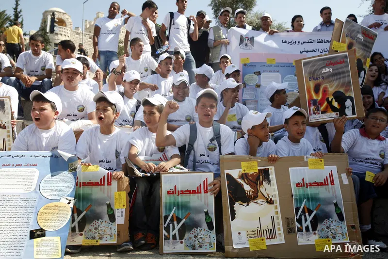 Palestinian children hold banners with slogans against drug during a rally as part of events of an International Day Against Drug in Jerusalem's Old City on June 26, 2012. Photo by Mahfouz Abu Turk