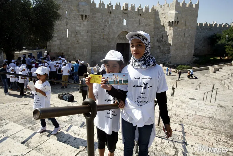 Palestinian children hold banners with slogans against drug during a rally as part of events of an International Day Against Drug in Jerusalem's Old City on June 26, 2012. Photo by Mahfouz Abu Turk