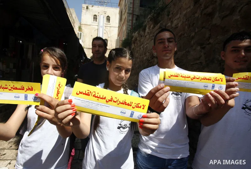 Palestinian children hold banners with slogans against drug during a rally as part of events of an International Day Against Drug in Jerusalem's Old City on June 26, 2012. Photo by Mahfouz Abu Turk