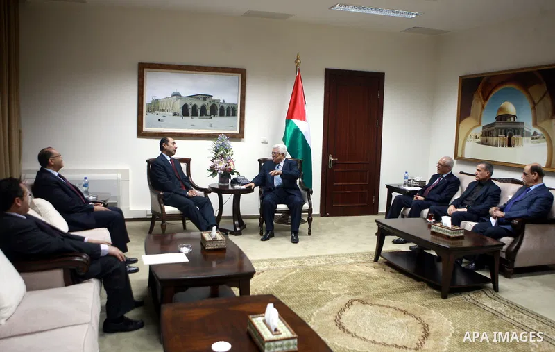 Palestinian President Mahmoud Abbas meets with the Egyptian Ambassador Hossam Zaki, before awards him the Presidential Medal of Distinction, in the West Bank city of Ramallah on 26 June 2012. Photo by Mohammed al-Ateeq