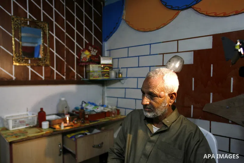 Anwar Sheikh-Eid, 42, performs Hijama or cupping therapy, to Palestinian patient Musa Sheikh El Eid at his shop in the southern Gaza Strip city of Rafah on 27 June 2012. Cupping is an ancient form of alternative medicine...