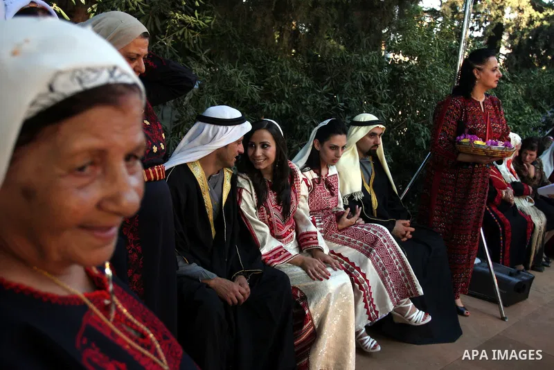 Palestinians wear Heritage fashions as they take part in a Palestinian wedding, during the opening of the "Heritage Week V in Birzeit 2012" in the old town of Birzeit in Ramallah, West Bank, 27 June 2012. Photo by Issam...