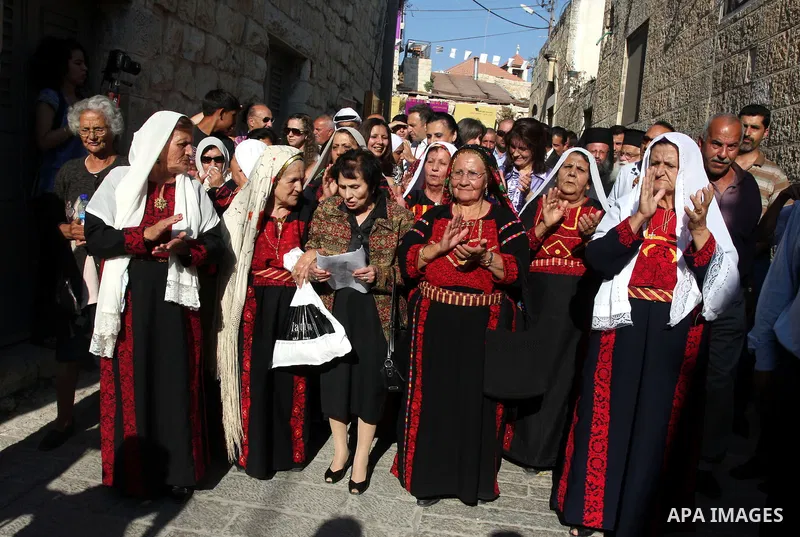 Palestinians sing folk songs as they take part in a Palestinian wedding, during the opening of the "Heritage Week V in Birzeit 2012" in the old town of Birzeit in Ramallah, West Bank, 27 June 2012. Photo by Issam Rimawi