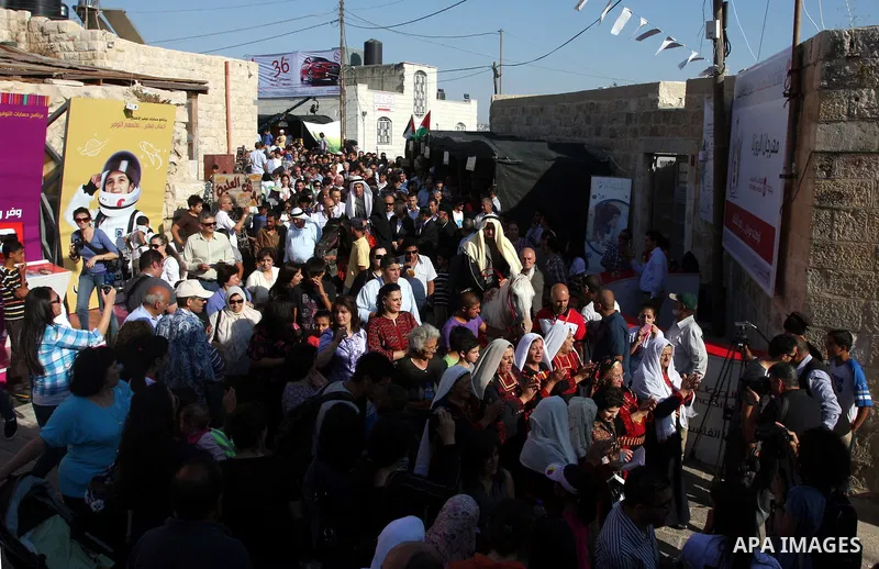 Palestinians sing folk songs as they take part in a Palestinian wedding, during the opening of the "Heritage Week V in Birzeit 2012" in the old town of Birzeit in Ramallah, West Bank, 27 June 2012. Photo by Issam Rimawi