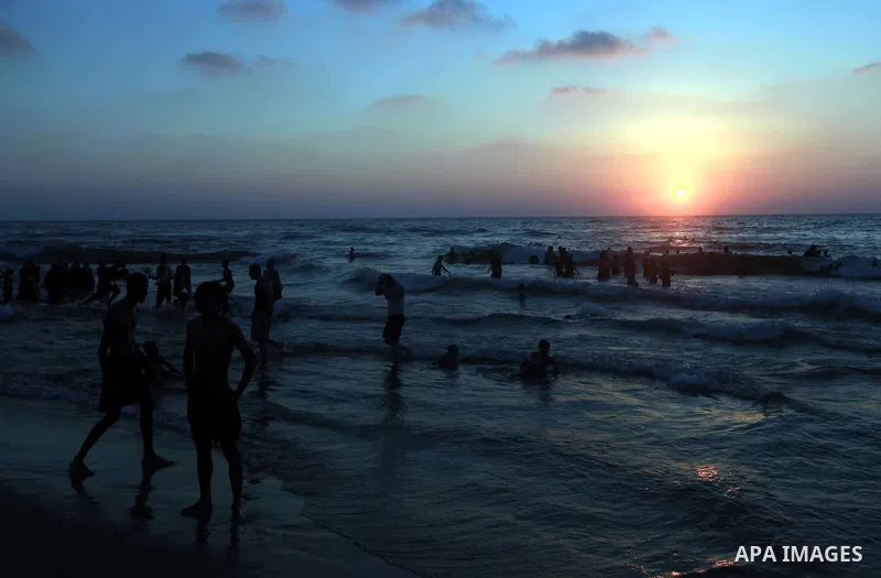 Palestinians enjoy swimming in the sea on Gaza's beach on 27 June 2012 in Gaza City . Photo by Majdi Fathi