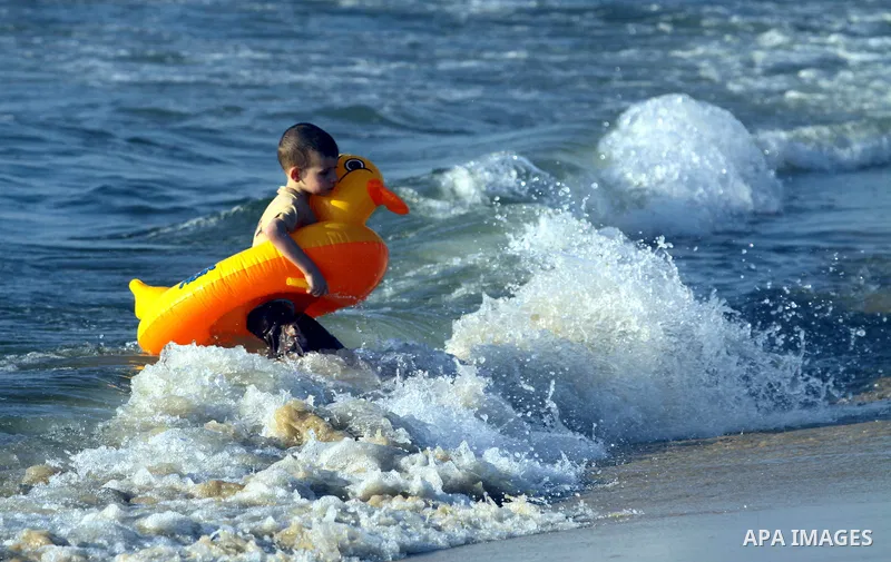 A Palestinian child enjoy swimming in the sea on Gaza's beach on 27 June 2012 in Gaza City . Photo by Majdi Fathi