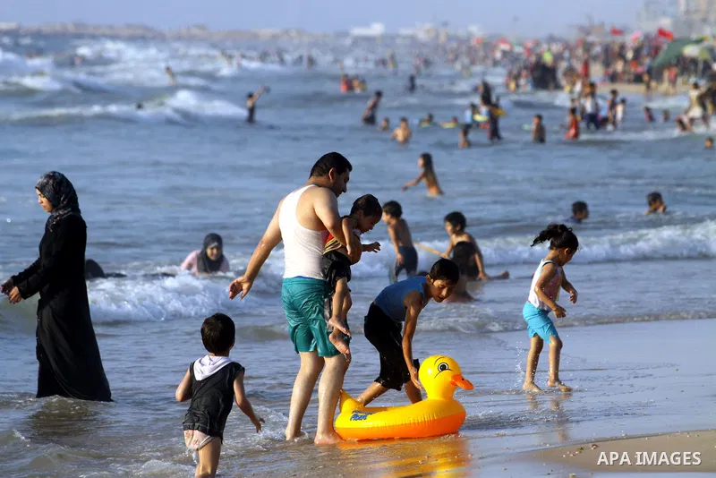 Palestinians enjoy swimming in the sea on Gaza's beach on 27 June 2012 in Gaza City . Photo by Majdi Fathi