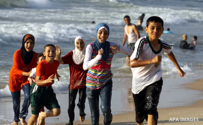 Palestinian children play at Gaza's beach on 27 June 2012 in Gaza . Photo by Majdi Fathi