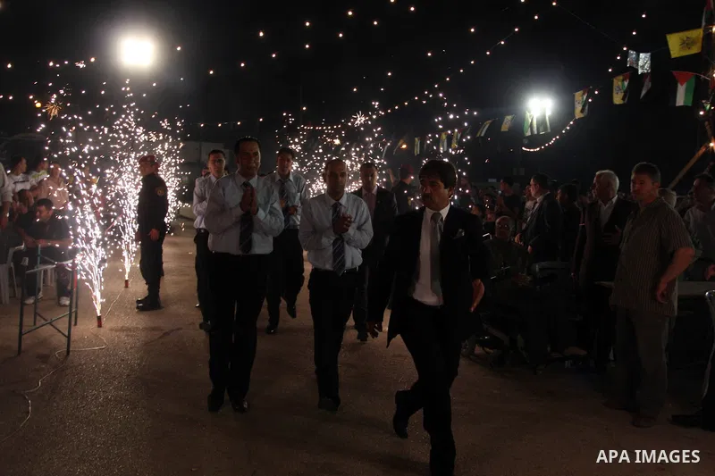 Palestinians celebrate during a mass wedding for 19 Groom, participation of Palestinian President Mahmoud Abbas (not seen) in the village of Silwad in the West Bank city of Ramallah, June 28, 2012. Photo by Issam Rimawi