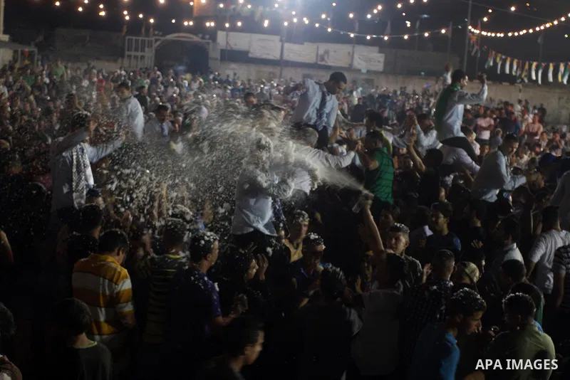 Palestinians celebrate during a mass wedding for 19 Groom, participation of Palestinian President Mahmoud Abbas (not seen) in the village of Silwad in the West Bank city of Ramallah, June 28, 2012. Photo by Issam Rimawi