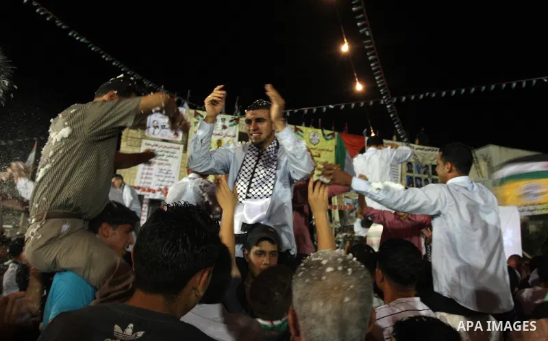 Palestinians celebrate during a mass wedding for 19 Groom, participation of Palestinian President Mahmoud Abbas (not seen) in the village of Silwad in the West Bank city of Ramallah, June 28, 2012. Photo by Issam Rimawi