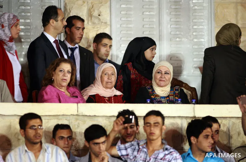 Palestinian President Mahmoud Abbas' wife attends a mass wedding for 19 Groom in the village of Silwad in the West Bank city of Ramallah, June 28, 2012. Photo by Thaer Ganaim