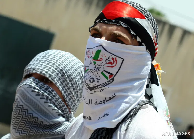Palestinian protestors throw stones during clashes with Israeli troops following a weekly protest against the Jewish settlement of Kdumim, near Nablus,in the northern West Bank village of Kufr Qaddum, June 29, 2012. Phot...