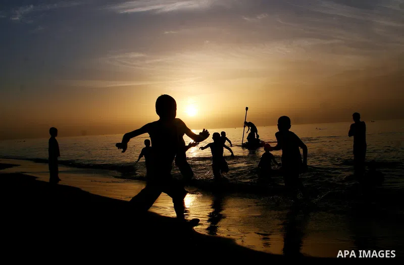 Palestinians enjoy swimming in the sea on Rafah's beach in the southern of Gaza strip,on 29 June 2012. Photo by Eyad Al Baba