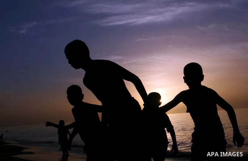 Palestinians enjoy swimming in the sea on Rafah's beach in the southern of Gaza strip,on 29 June 2012. Photo by Eyad Al Baba