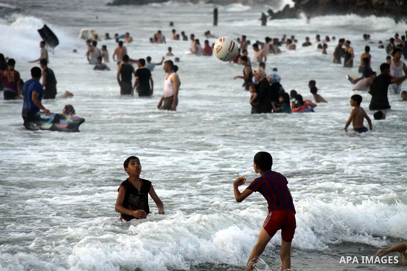 Palestinians enjoy swimming on their week-end in the Mediterranean sea in Gaza City on June 29, 2012. Photo by Majdi Fathi