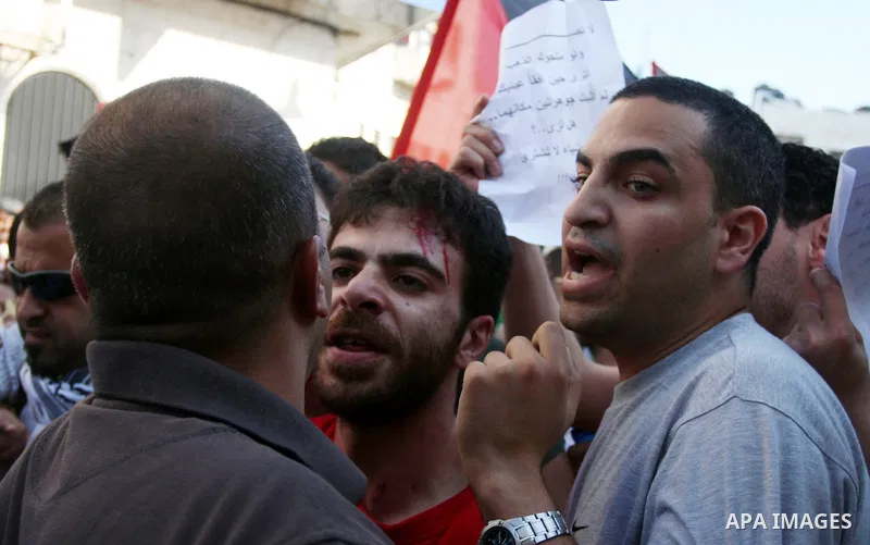 Palestinian police control the crowd in the West Bank city of Ramallah, on June 30, 2012, during a protest against a planned meeting between Palestinian leader Mahmud Abbas and Israel's vice prime minister Shaul Mofaz. T...