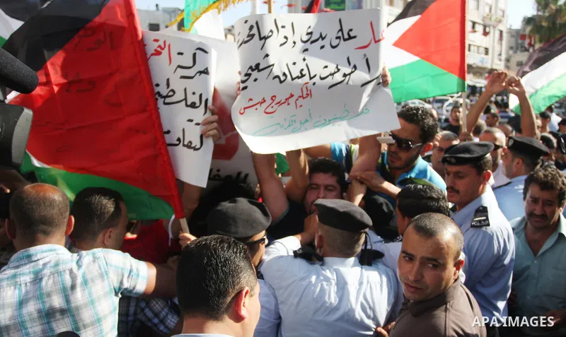 Palestinian police control the crowd in the West Bank city of Ramallah, on June 30, 2012, during a protest against a planned meeting between Palestinian leader Mahmud Abbas and Israel's vice prime minister Shaul Mofaz. T...