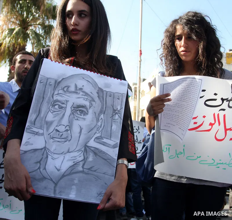Palestinians shout slogans during a protest against a meeting between Palestinian President Mahmoud Abbas and Israeli Vice Prime Minister Shaul Mofazin, in the West Bank city of Ramallah, Saturday, June 30, 2012. A sched...