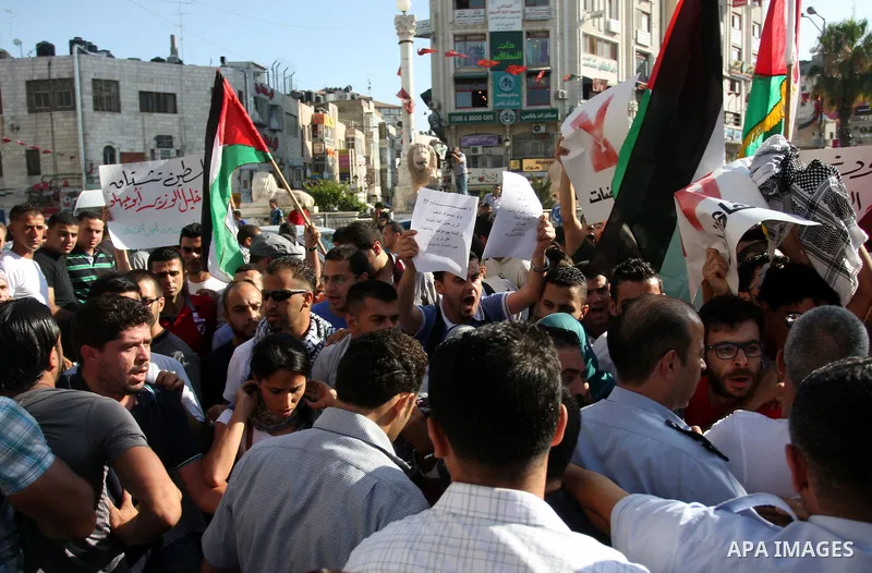 Palestinian police control the crowd in the West Bank city of Ramallah, on June 30, 2012, during a protest against a planned meeting between Palestinian leader Mahmud Abbas and Israel's vice prime minister Shaul Mofaz. T...