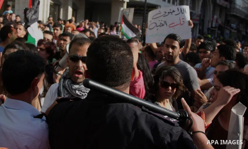Palestinian police control the crowd in the West Bank city of Ramallah, on June 30, 2012, during a protest against a planned meeting between Palestinian leader Mahmud Abbas and Israel's vice prime minister Shaul Mofaz. T...