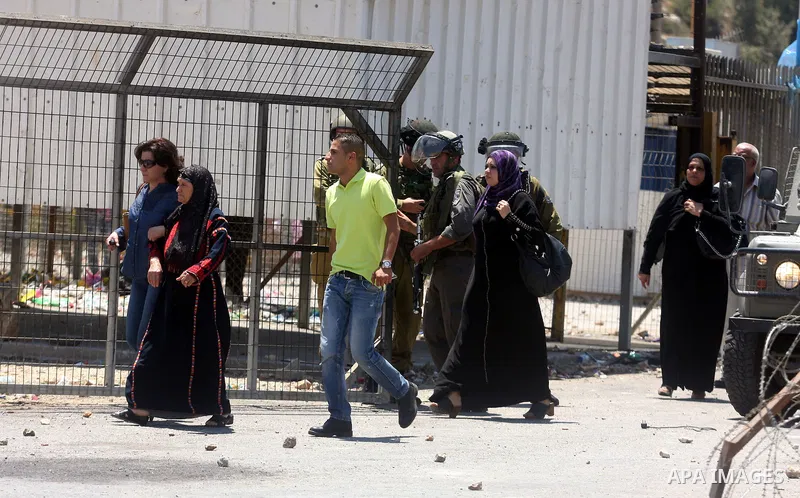 Israeli soldiers take cover during clashes with Palestinian protestors following a demonstration outside Ofer prison, near the West Bank city of Ramallah,on Sunday, July, 1, 2012. Photo by Issam Rimawi