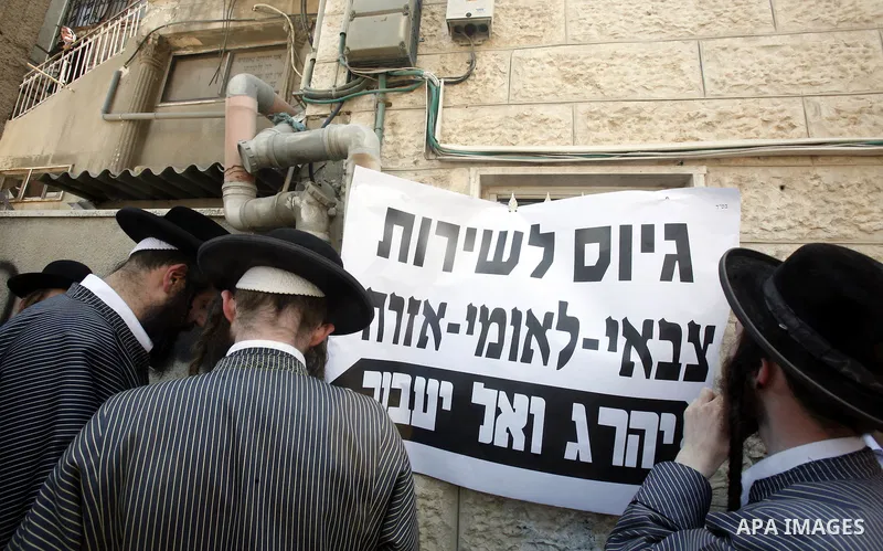 Ultra-Orthodox Jewish hold banners with slogans against involvement in the Israeli army during a protest in the west Jerusalem, on 01 July 2012. Photo by Mahfouz Abu Turk